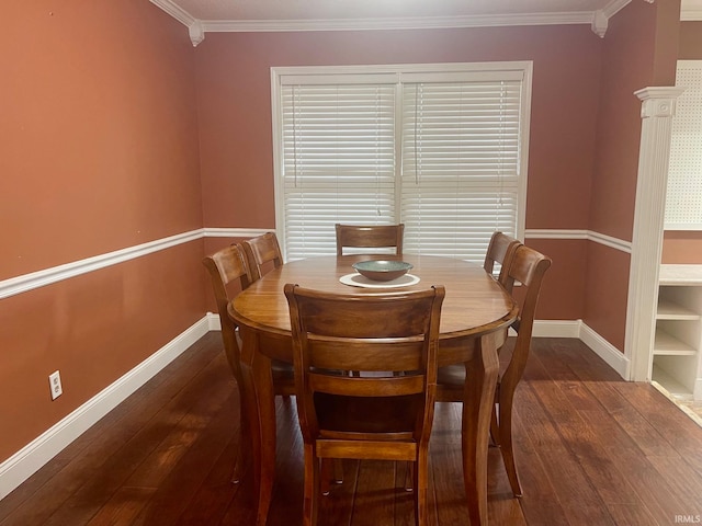 dining room featuring ornamental molding and dark hardwood / wood-style flooring