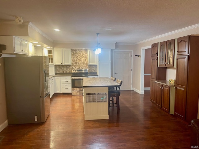 kitchen with a center island, dark hardwood / wood-style floors, white cabinetry, a kitchen breakfast bar, and appliances with stainless steel finishes