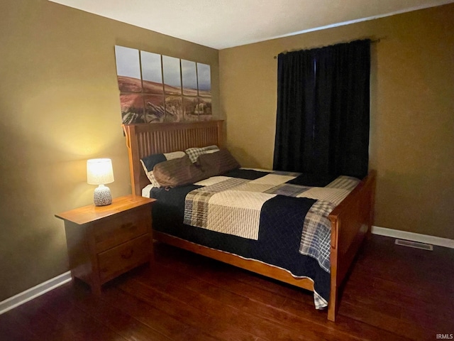 bedroom featuring dark wood-type flooring