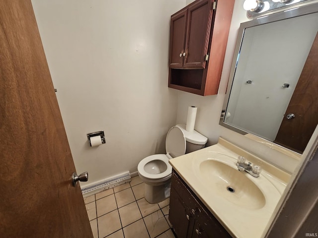 bathroom with a baseboard heating unit, tile patterned flooring, vanity, and toilet