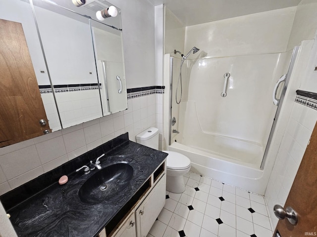 full bathroom featuring tile walls, tub / shower combination, vanity, and toilet