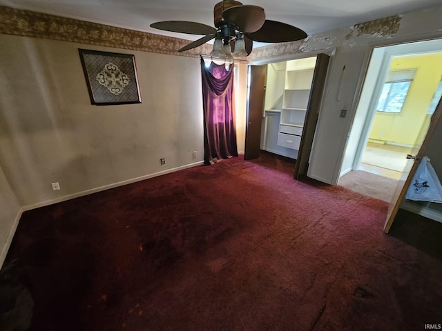 interior space with carpet flooring and ceiling fan