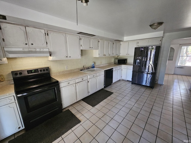 kitchen with white cabinetry, tasteful backsplash, light tile patterned floors, black appliances, and sink