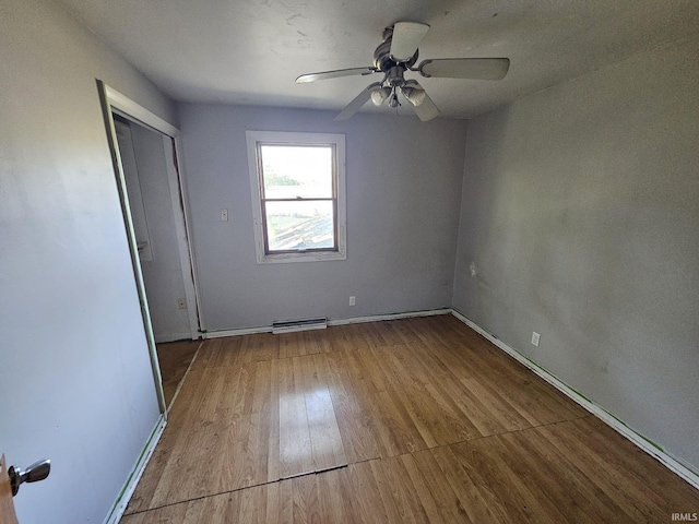 unfurnished bedroom featuring light hardwood / wood-style floors, ceiling fan, and a closet