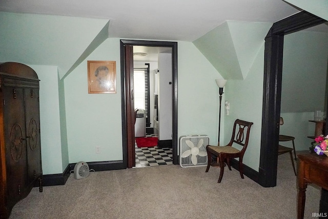 sitting room with vaulted ceiling and light colored carpet