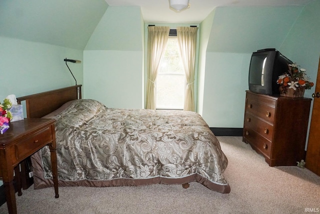 carpeted bedroom with vaulted ceiling