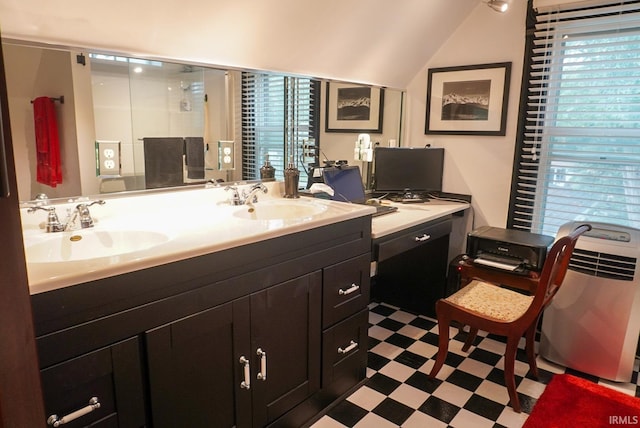 bathroom featuring lofted ceiling and sink