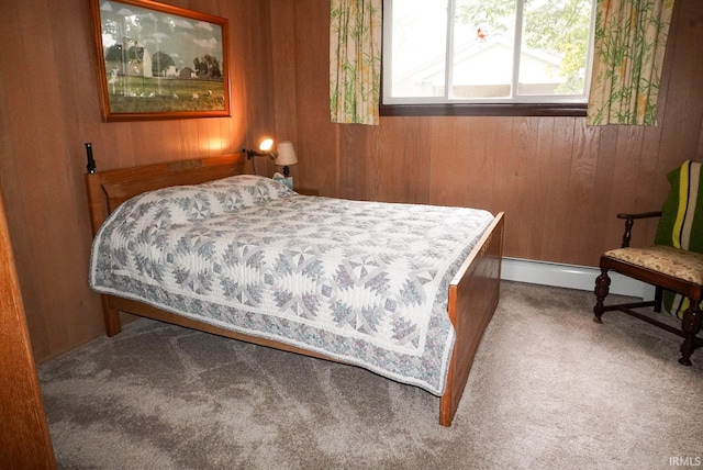 bedroom featuring carpet floors, wooden walls, and a baseboard radiator