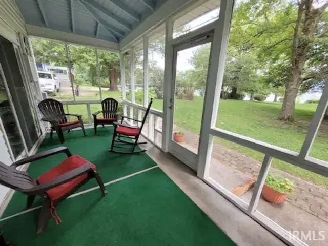 sunroom featuring lofted ceiling