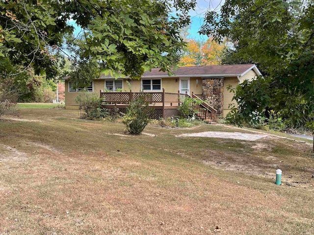 view of front of house featuring a front yard and a deck