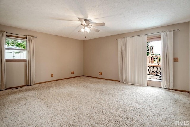 spare room featuring ceiling fan, carpet floors, and a textured ceiling