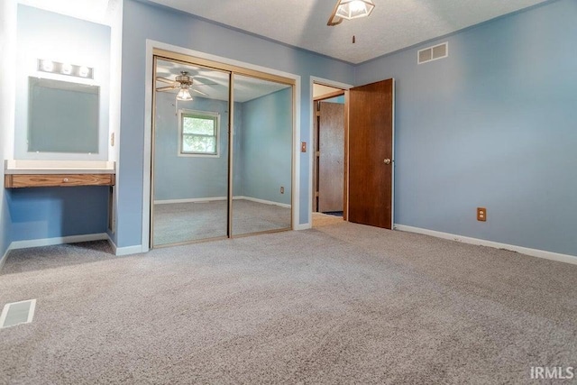 unfurnished bedroom with baseboards, visible vents, a closet, and carpet flooring