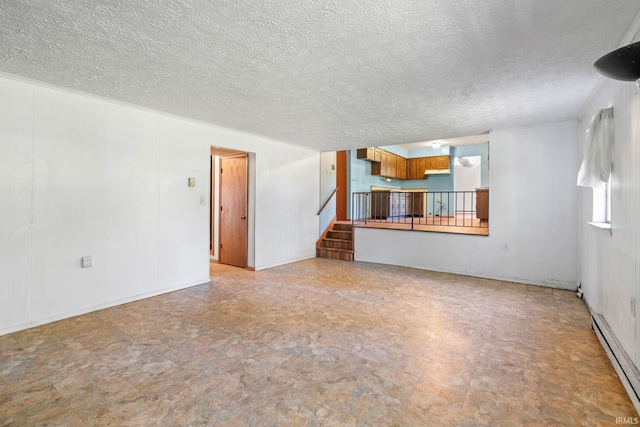 unfurnished living room with a textured ceiling and a baseboard heating unit