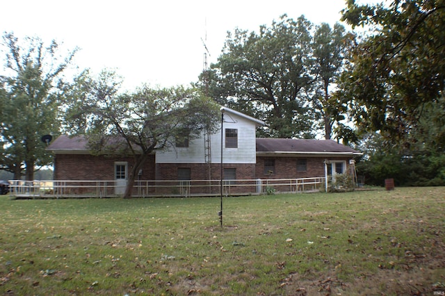 rear view of property with a yard