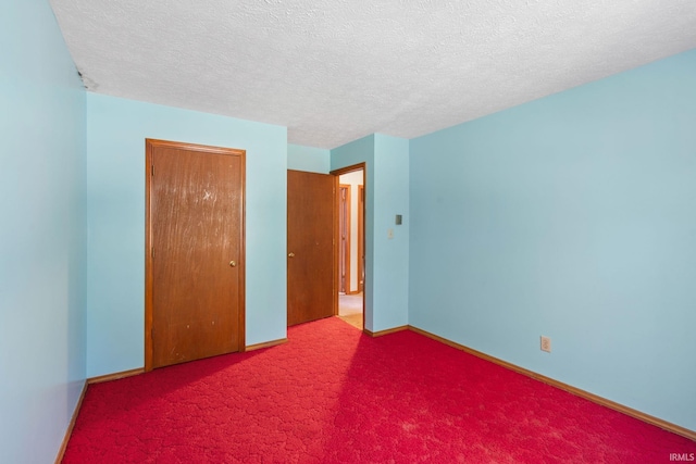 unfurnished bedroom with carpet flooring and a textured ceiling