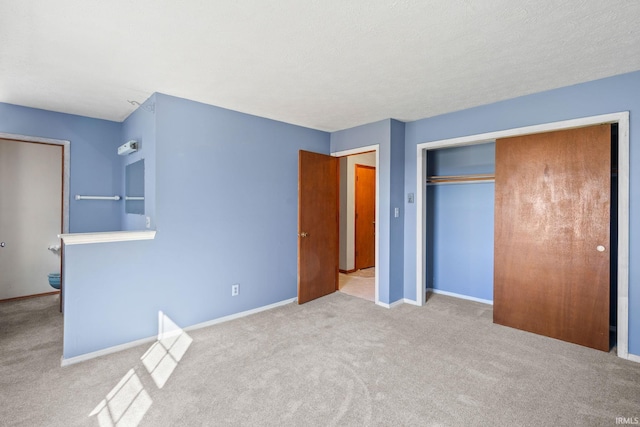 unfurnished bedroom featuring a closet and light colored carpet