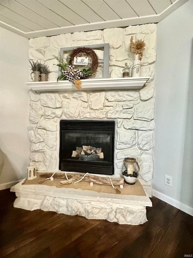 interior details with wood-type flooring and a fireplace