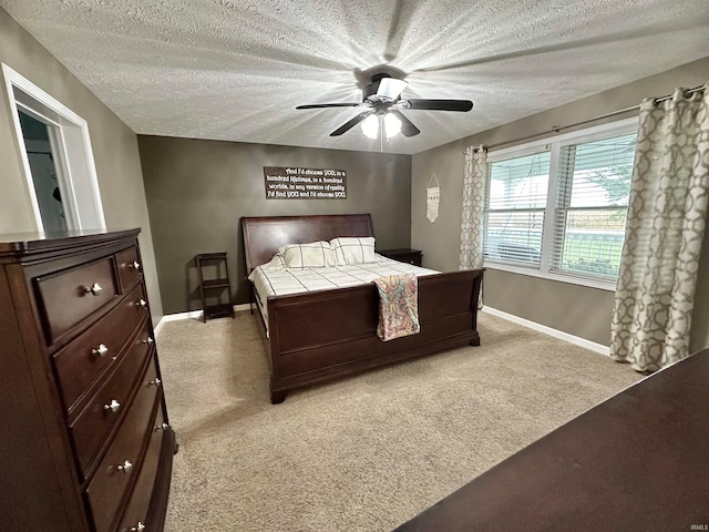 carpeted bedroom with ceiling fan and a textured ceiling