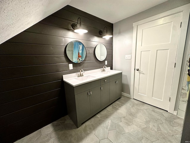 bathroom featuring wooden walls and vanity