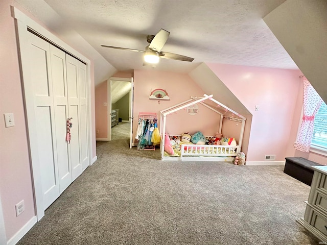 unfurnished bedroom with a closet, vaulted ceiling, ceiling fan, and carpet flooring