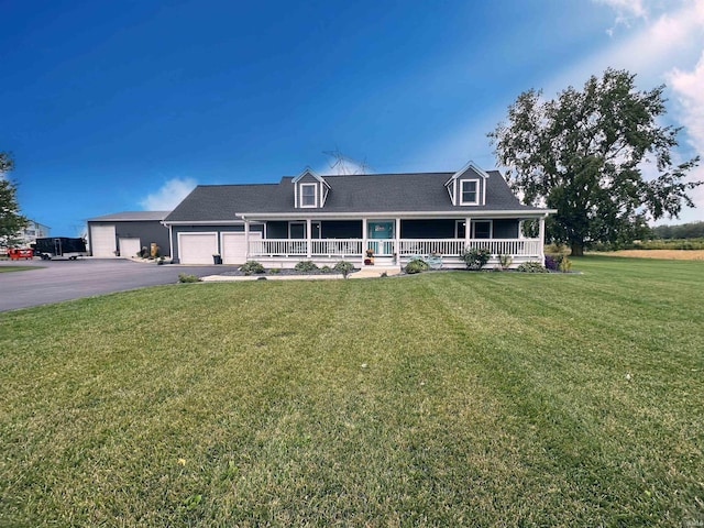 view of front of house with a front yard, a garage, and a porch