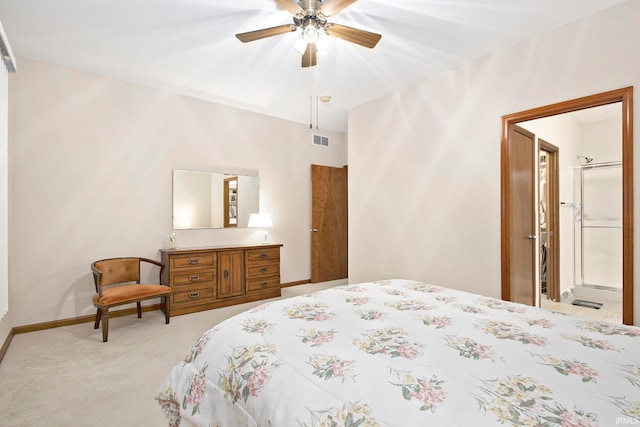 bedroom with light carpet, ceiling fan, and ensuite bathroom