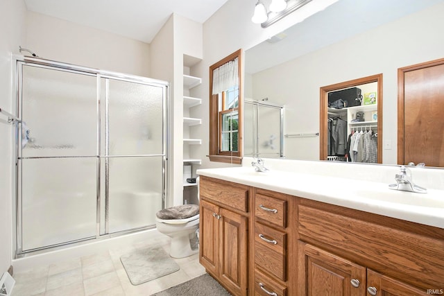 bathroom featuring walk in shower, vanity, toilet, and tile patterned floors