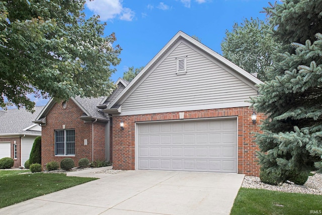 view of front of house with a garage and a front lawn