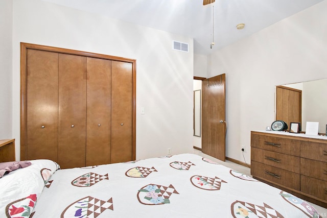 bedroom with a closet and high vaulted ceiling