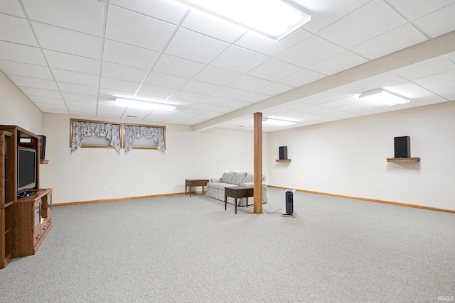 basement with carpet and a paneled ceiling