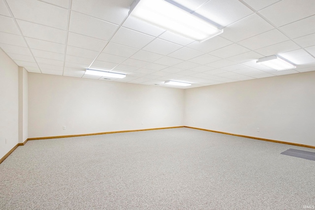 spare room featuring carpet floors and a drop ceiling