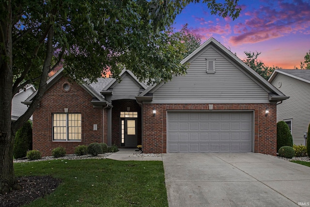 view of property featuring a garage and a yard