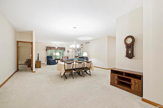 dining space with light colored carpet and a notable chandelier