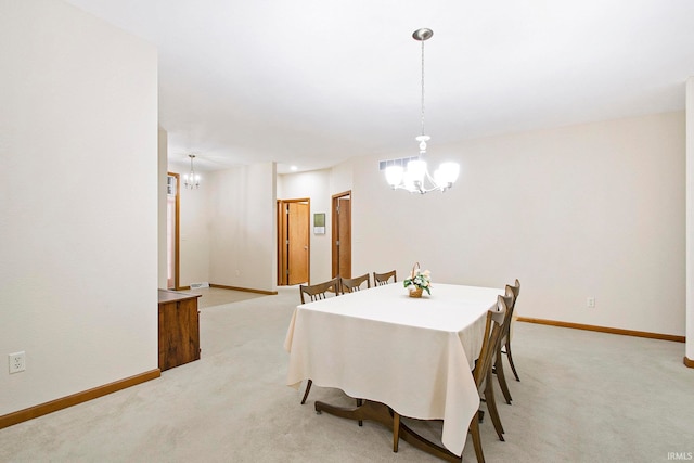 carpeted dining area featuring a notable chandelier