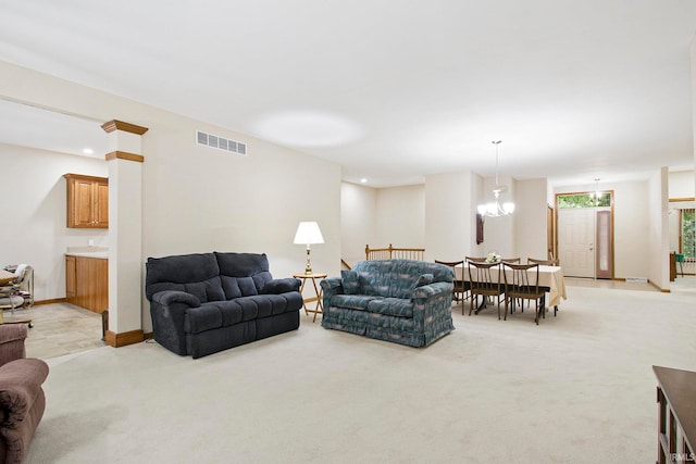 living room with a chandelier and light colored carpet