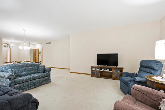 living room with light colored carpet and a chandelier