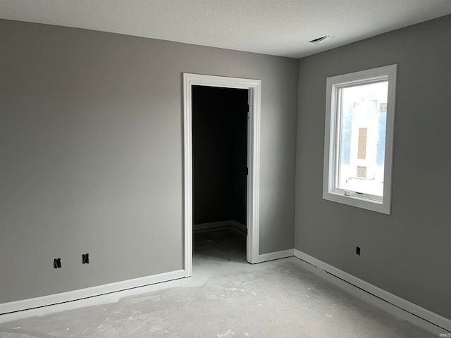 spare room with a textured ceiling