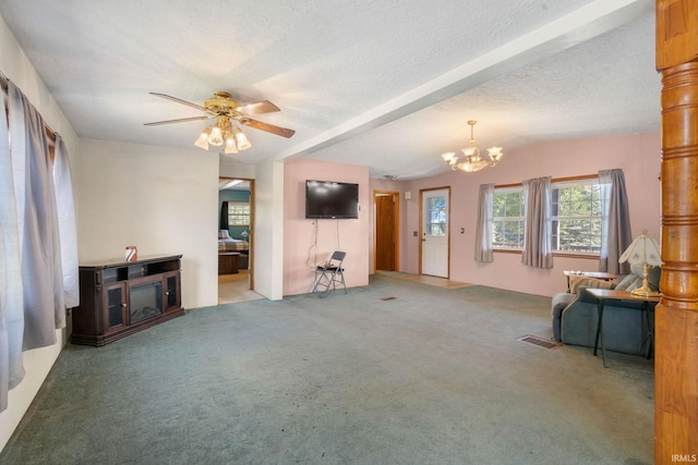 living room featuring a textured ceiling, carpet, and ceiling fan with notable chandelier