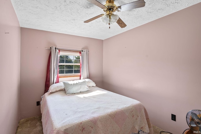 bedroom featuring a textured ceiling, carpet, and ceiling fan