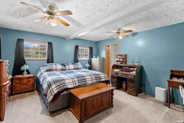 carpeted bedroom with beam ceiling, multiple windows, ceiling fan, and a textured ceiling