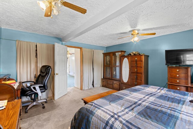 bedroom featuring a textured ceiling, beam ceiling, light carpet, and ceiling fan