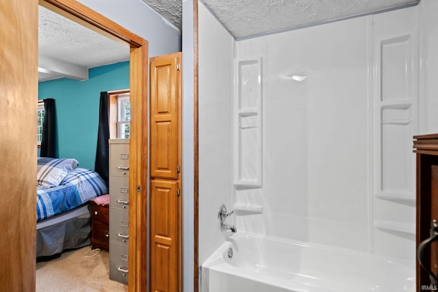 bathroom with a textured ceiling and shower / bathtub combination