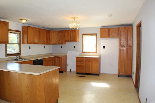 kitchen with pendant lighting, a chandelier, a healthy amount of sunlight, and sink