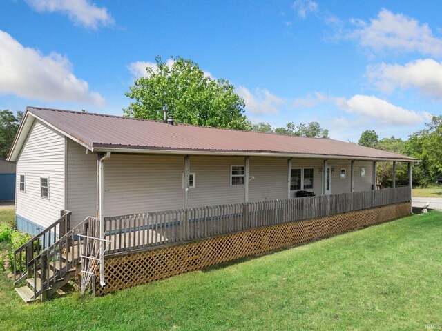 rear view of house with a lawn