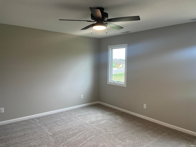 spare room with ceiling fan and carpet