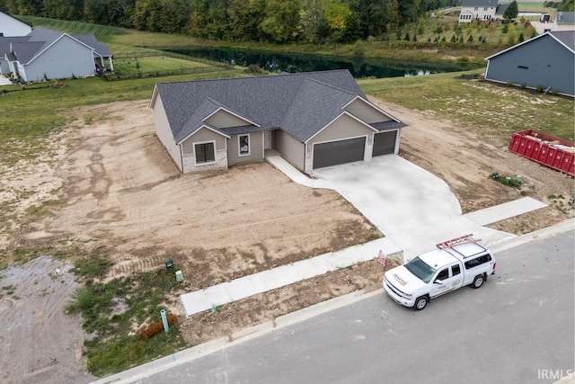 birds eye view of property with a water view