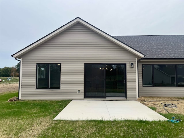 back of property featuring a yard and a patio area