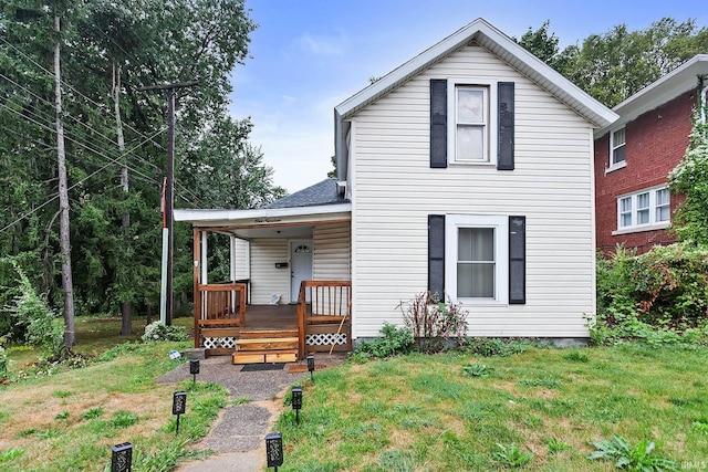 view of front of house featuring a porch and a front lawn