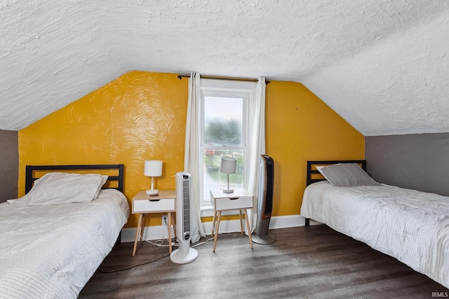 bedroom with lofted ceiling and a textured ceiling