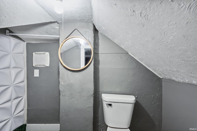 bathroom with toilet and vaulted ceiling